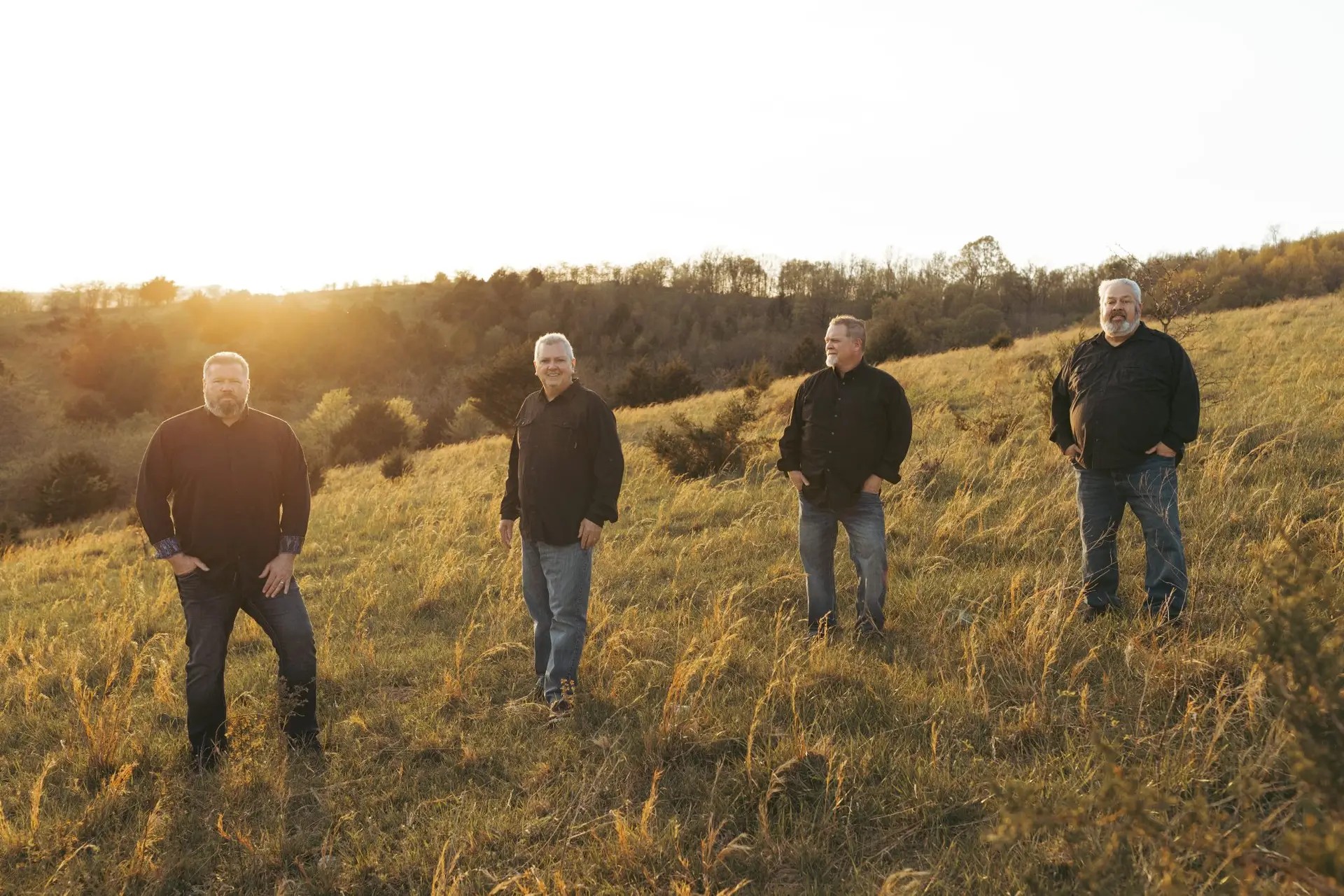 Mid South Boys standing on a hillside at golden hour